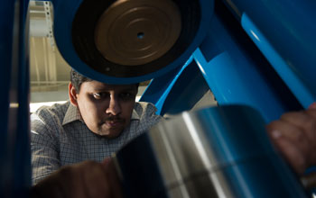 Geologist Rajdeep Dasgupta using hydraulic presses to crush rocks at high pressures.