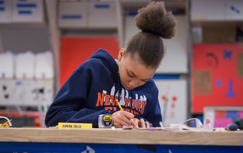 A student calculates measurements in one of the makerspaces involved in Designing for Diversity.