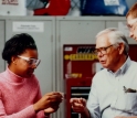 Students and a professor discuss engineering concepts during a Learning Factory exercise.