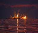 Photo showing flares of captured gas and oil at the Deepwater Horizon spill site in June 2010.