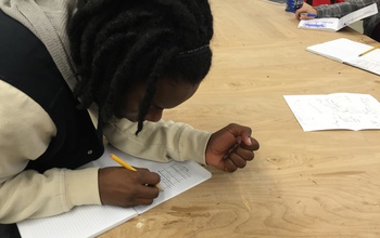 girl drawing on a notebook