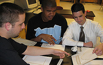 Photo of teacher Judson Wagner working on bridge designs with his physics students.