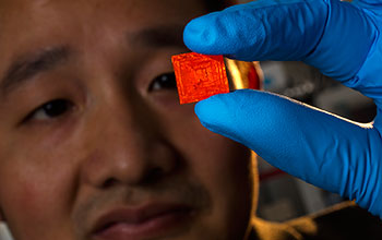 Engineer Jinsong Huang holds a crystal that can detect significantly smaller doses of X-rays