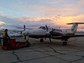 The King Air moves into a hangar; snow clouds are in the background.