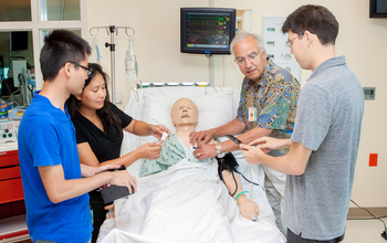 researcher and students experiment with a mannequin