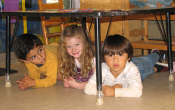 Photo of pre-school students practicing Drop, Cover and Hold On in Santa Barbara, Calif.