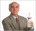 Photo of G.K. Surya Prakash holding a liquid-methanol fuel cell.