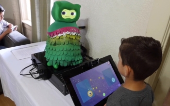 child sitting in front of robot