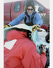 Photo shows Gretchen Hofmann using a towel to cut out reflected sunlight.