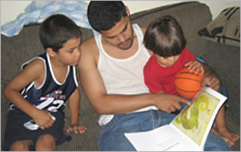 Father reading to children.