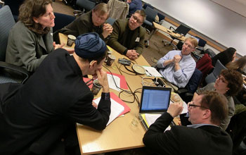 group of people discussing at a table