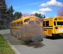 School bus spewing smoke through exhaust pipe