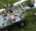 Three photos of SAAST student-built robot picking up a stack of hockey pucks in a sequence.