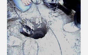 One of the search and rescue robots enters a sewer.