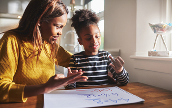 Parent helping daughter with math.