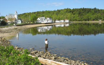 Photo of Lyndie Hice checking water temperature and salinity along the coast of Maine.