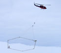 Photo of a helicopter deploying SkyTem mapping technology in Antarctica.