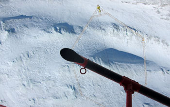 Image looking from a helicopter down to a mapping device in Antarctica.
