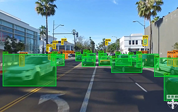 Street view with green boxes identifying cars