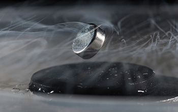 a magnet floats above a superconductor cooled with liquid nitrogen