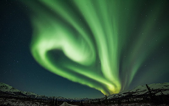 The aurora borealis’ swirling curtains of green light, captured in Alaska.
