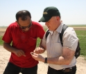 Photo of project co-directors Annas and Gil Stein examining a sherd of pottery at Tell Zeidan.