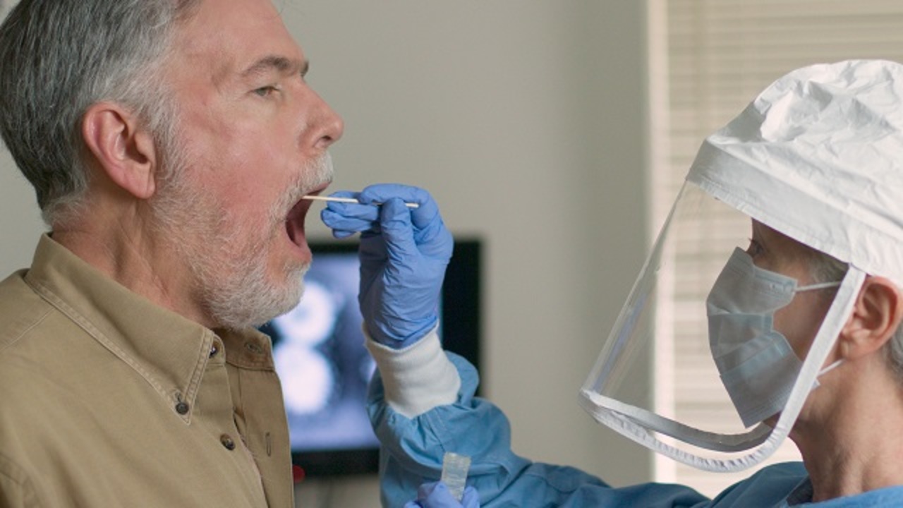 man being tested with a cotton swab