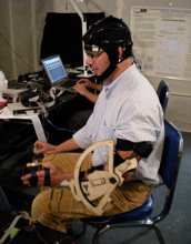 University of Michigan engineering researcher Brent Gillespie uses a prototype of a device.