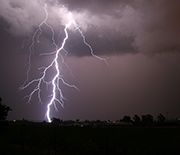 A cloud-to-ground lightning strike during a nighttime thunderstorm in the U.S. Midwest.