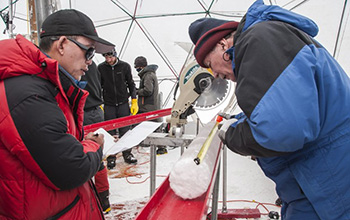 Scientists study an ice core from the Guliya ice cap; the ice held ancient viruses