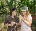 Photo of grad students examining mosquitoes.
