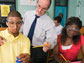 Photo of a teacher with two students carrying out a science experiment.