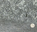 Crystals in sheet-like basalt compared to the size of a quarter, near Rapidan, Va.
