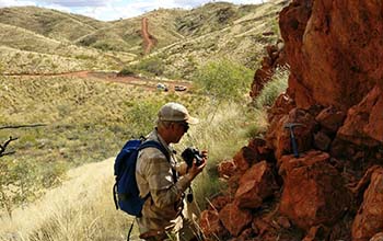 Benjamin Johnson woks at an outcrop in remote Western Australia