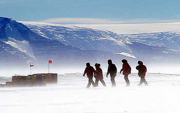 Group of researchers and harsh landscape.