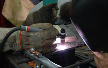 A person learning to weld.