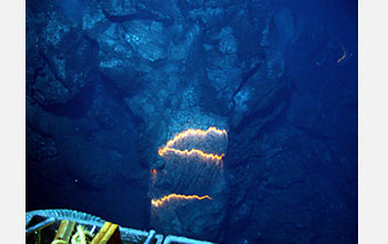 Photo showing a pillow lava tube extending downslope in an area about three feet across.