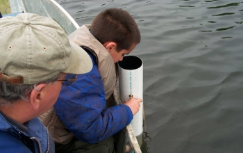 Citizen volunteers have been trained to measure water clarity with a Secchi disk and view tube.