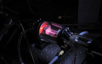 a hollow waveguide filled with high-pressure helium gas as X-ray beam is generated.