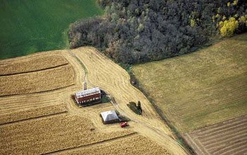 Aerial view of a rural farm surrounded by cornfields in the Yahara watershed.
