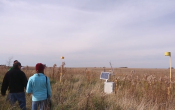 researchers standing in field