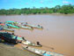 boats anchored along the shoreline of a river