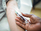 nurse drawing blood from a patient