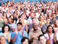 a crowd of people sitting in a stadium