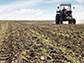 a farmer on a tractor plowing a field