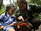 girls looking at leaves