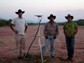 researchers standing next to a GPS station