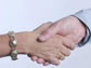 handshake between a woman and man