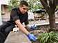 Kyle Costa collecting soil in the courtyard of Beckman Institute