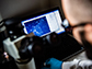 a graduate student looks at cells under a lab scope